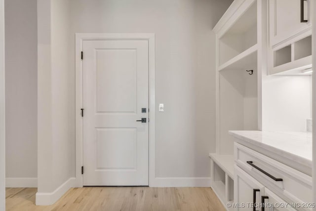 mudroom with light hardwood / wood-style flooring