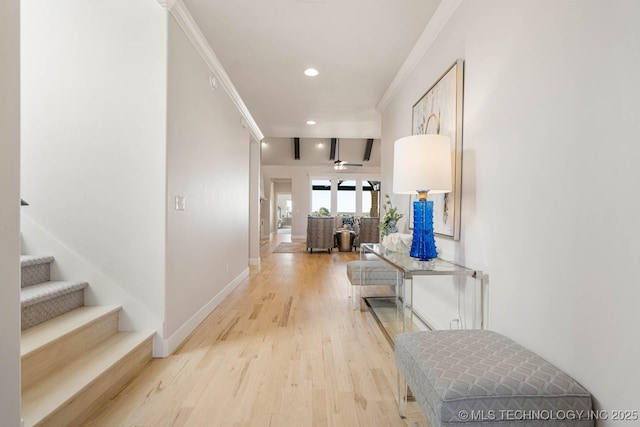 hall featuring light hardwood / wood-style flooring and ornamental molding