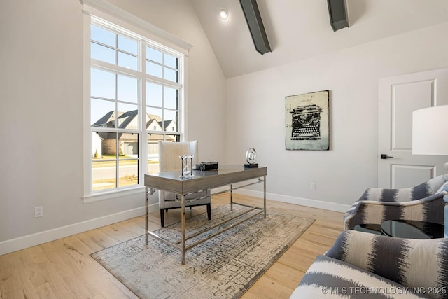 home office featuring lofted ceiling with beams and light hardwood / wood-style flooring