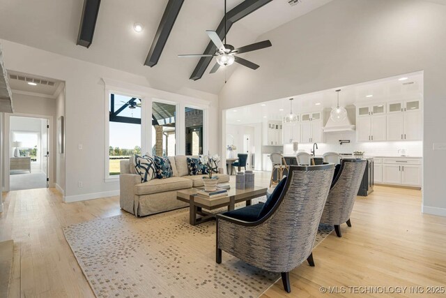 living room featuring ceiling fan, beamed ceiling, high vaulted ceiling, and light wood-type flooring