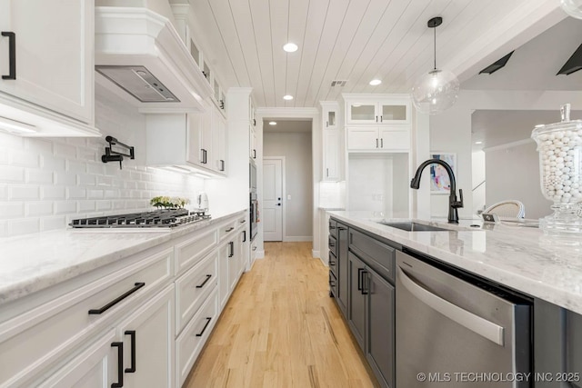 kitchen featuring white cabinets, wood ceiling, decorative light fixtures, and appliances with stainless steel finishes