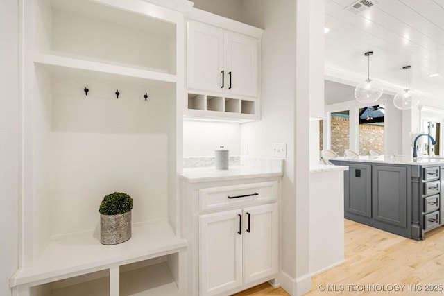 mudroom featuring sink and light hardwood / wood-style floors