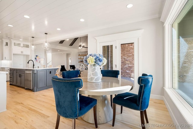 dining space featuring lofted ceiling with beams, light hardwood / wood-style flooring, ceiling fan, and wooden ceiling