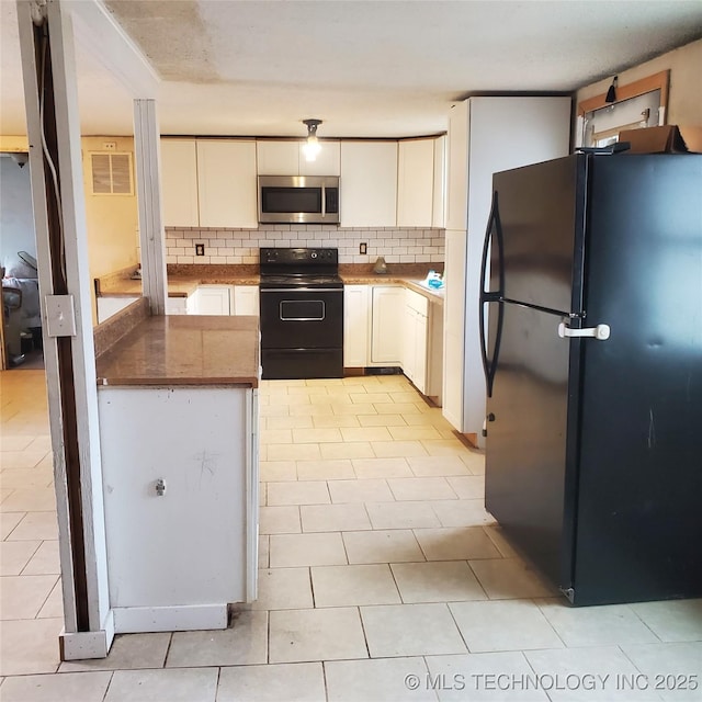 kitchen with tasteful backsplash, light tile patterned floors, black appliances, and white cabinets