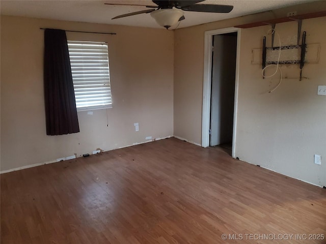 unfurnished room featuring ceiling fan and hardwood / wood-style floors