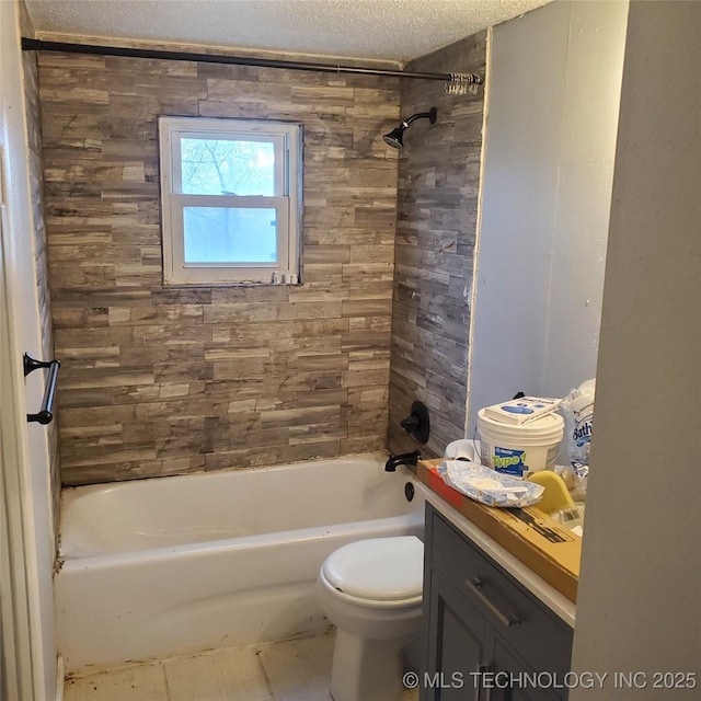 full bathroom with vanity, toilet, tiled shower / bath combo, and a textured ceiling