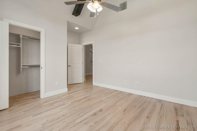 unfurnished bedroom featuring a closet, high vaulted ceiling, ceiling fan, and light hardwood / wood-style flooring