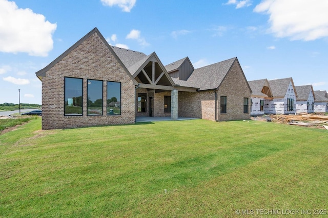 craftsman house featuring a front lawn and brick siding