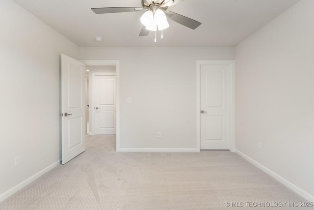 unfurnished bedroom with light colored carpet, a ceiling fan, and baseboards