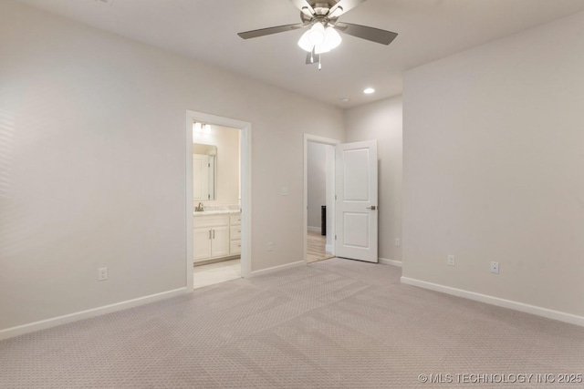 unfurnished bedroom with light colored carpet, a sink, baseboards, connected bathroom, and recessed lighting