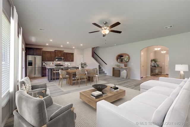 living room featuring ceiling fan and light hardwood / wood-style floors