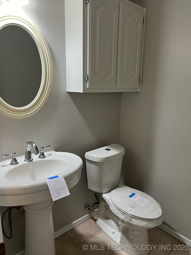 bathroom featuring tile patterned flooring and toilet