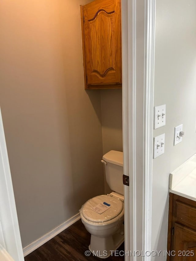 bathroom featuring hardwood / wood-style floors, vanity, and toilet