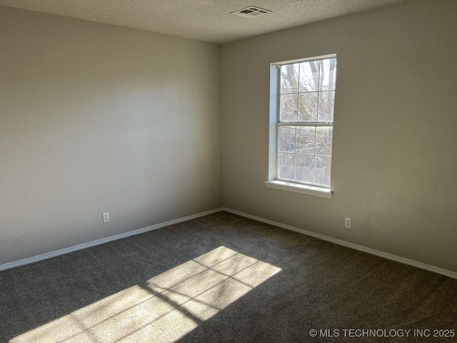 carpeted spare room with a textured ceiling