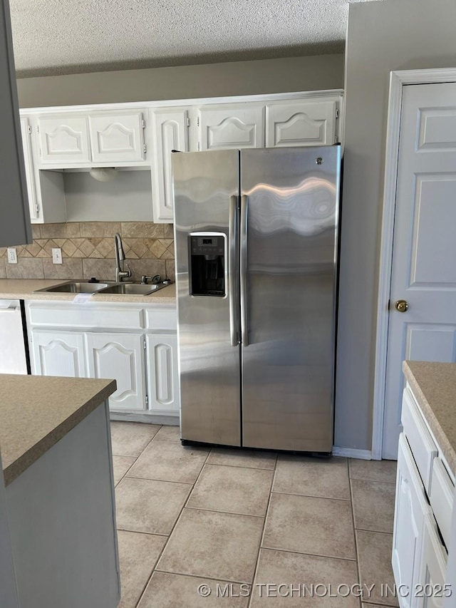 kitchen with white cabinets and stainless steel fridge with ice dispenser