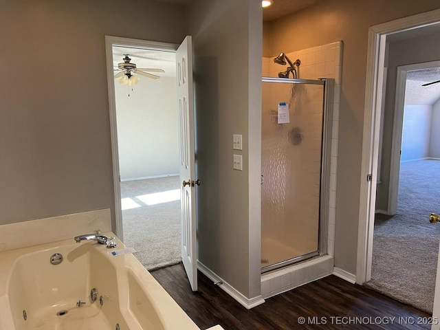 bathroom with ceiling fan, plus walk in shower, and wood-type flooring