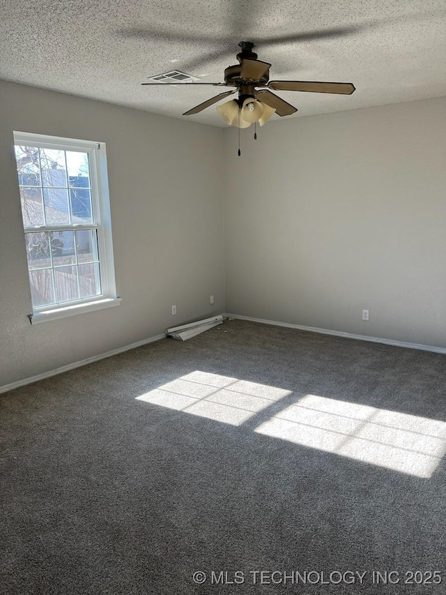 carpeted spare room with ceiling fan and a textured ceiling