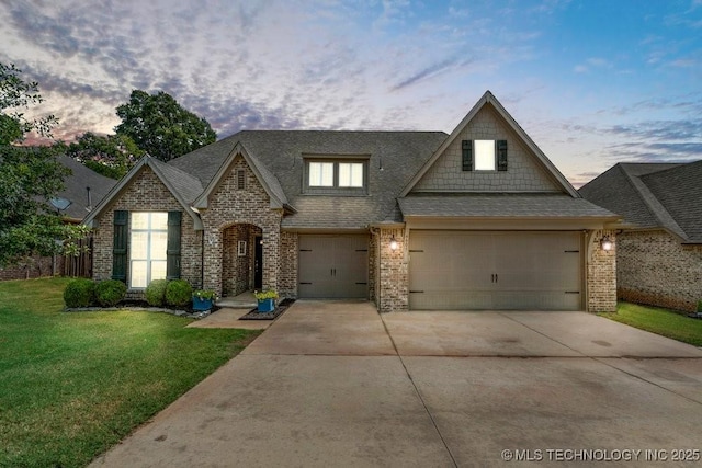 view of front of home featuring a yard and a garage