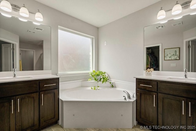 bathroom with a bath and vanity