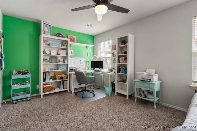 carpeted office with ceiling fan