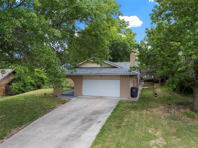 view of front of house with a garage and a front yard