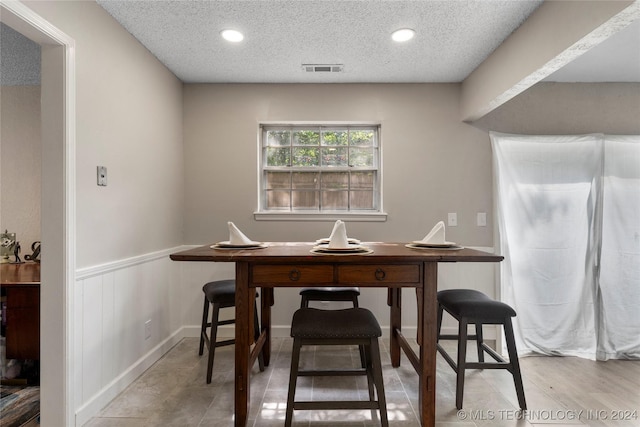 dining area with a textured ceiling