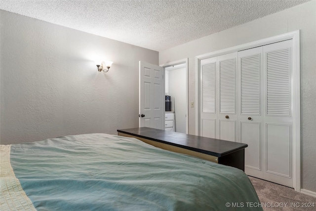 carpeted bedroom featuring a textured ceiling and a closet