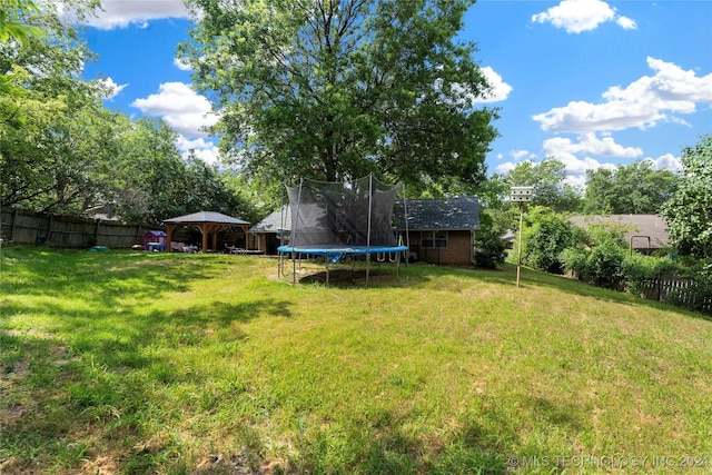 view of yard featuring a gazebo and a trampoline