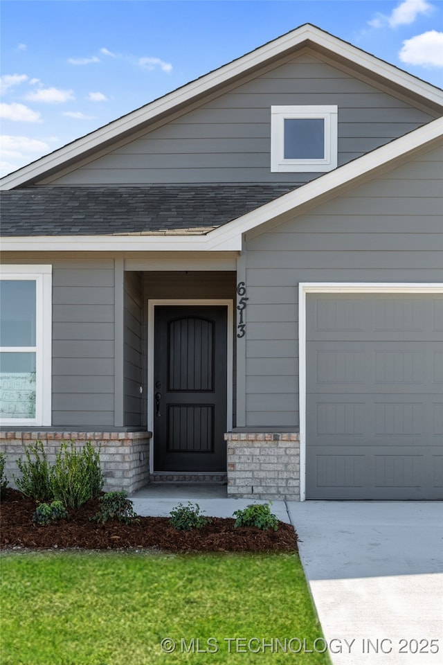 doorway to property with a garage