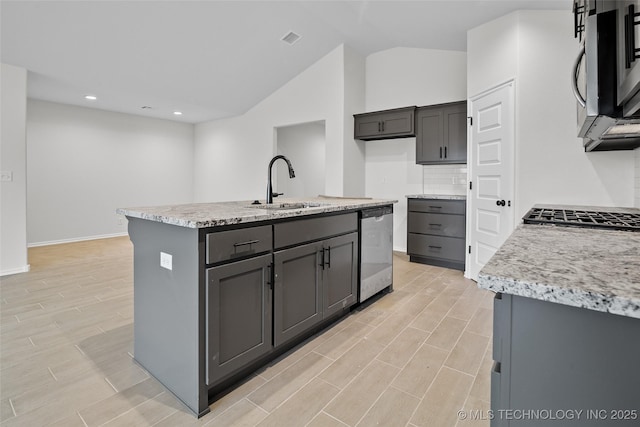 kitchen with gray cabinetry, sink, an island with sink, and stainless steel appliances