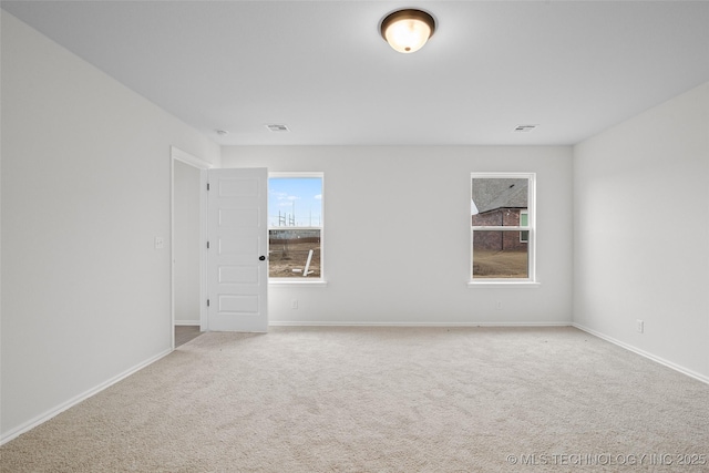 spare room with light colored carpet