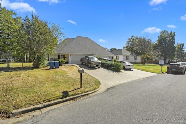 view of front of property featuring a garage and a front yard