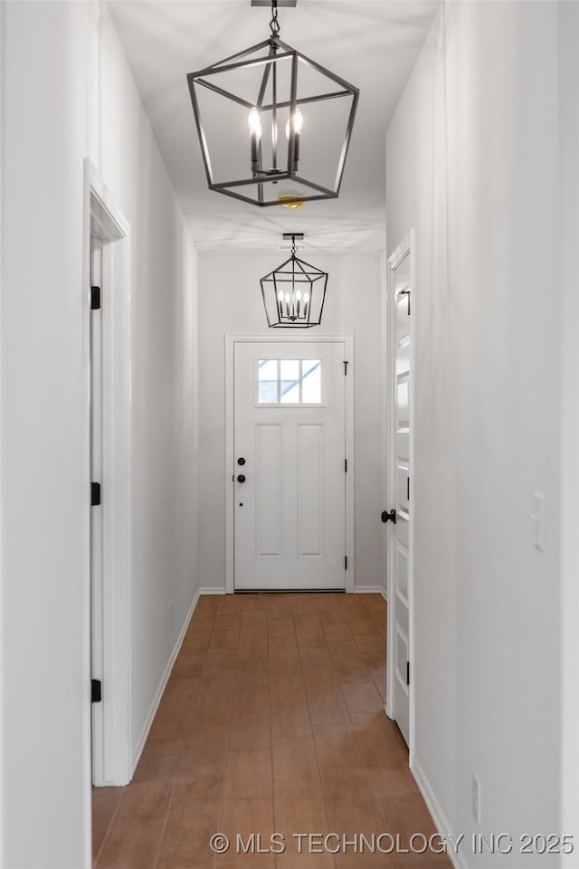 entryway featuring an inviting chandelier