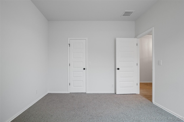 unfurnished bedroom with a closet and carpet