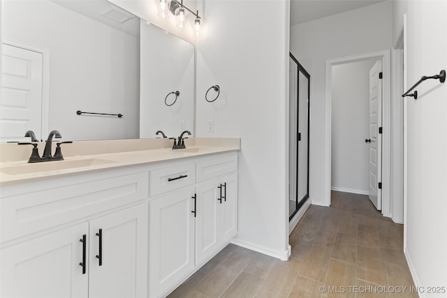 bathroom featuring vanity and an enclosed shower