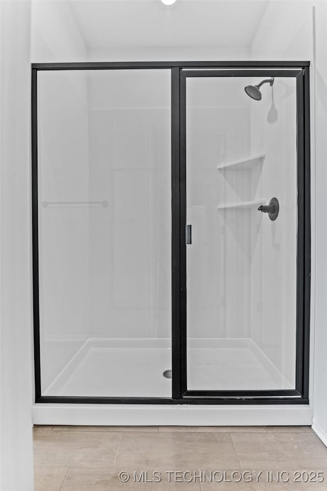 bathroom with a shower with door