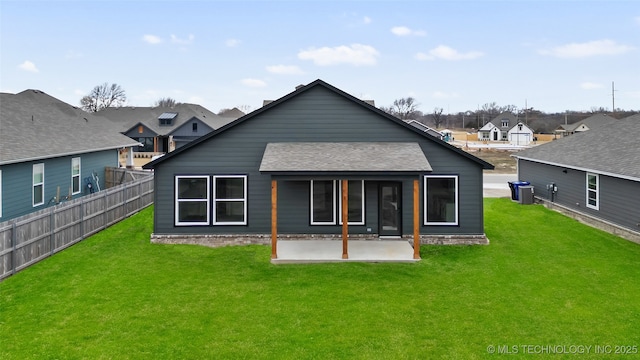 back of property featuring a lawn, central AC unit, and a patio area