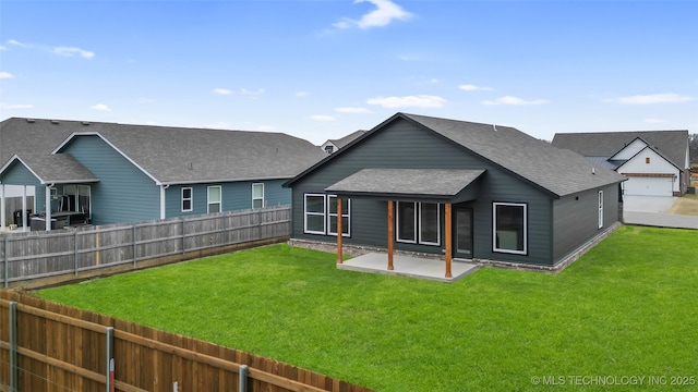 back of house with a patio and a yard