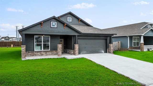 craftsman inspired home featuring a garage and a front lawn