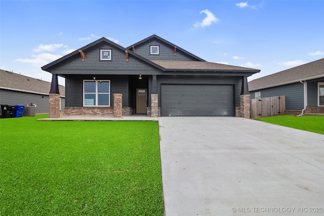 craftsman inspired home featuring a porch, a garage, central AC unit, and a front yard