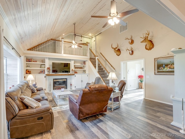 living room featuring ceiling fan, built in features, wood ceiling, and high vaulted ceiling