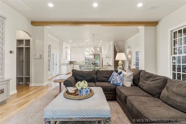 living room featuring beam ceiling and light hardwood / wood-style floors