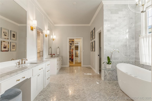 bathroom with ornamental molding, vanity, a tub, and a notable chandelier