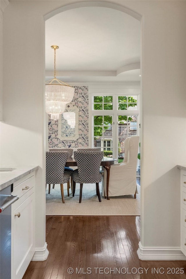 dining room featuring dark hardwood / wood-style flooring and a notable chandelier