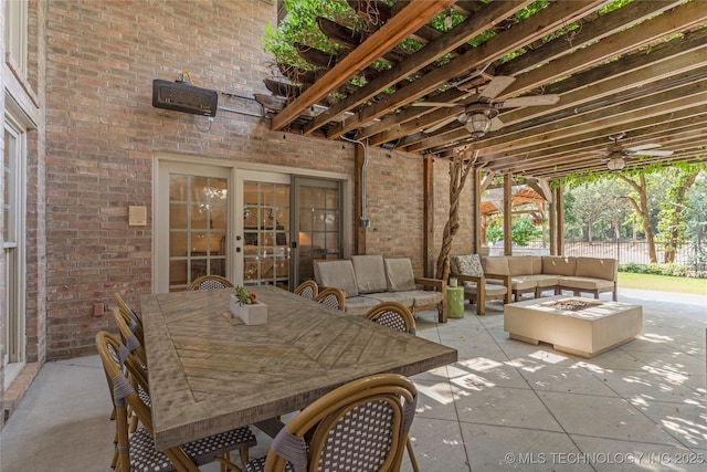 view of patio / terrace featuring an outdoor living space with a fire pit