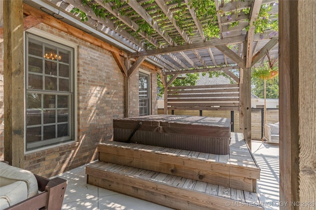 wooden terrace featuring a pergola and a covered hot tub