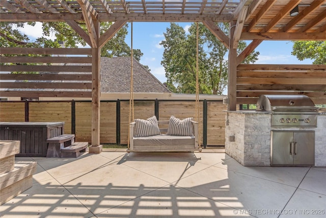 view of patio with exterior kitchen, a grill, and a pergola