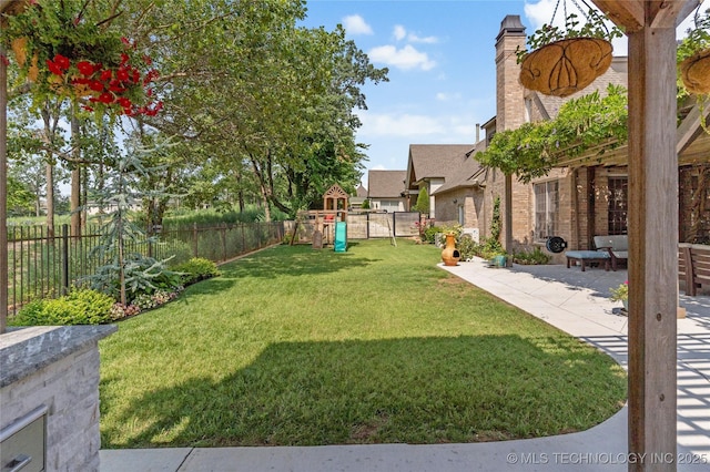 view of yard with a playground and a patio