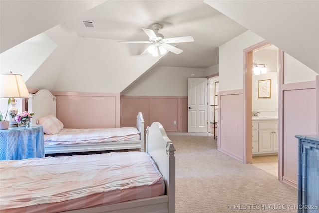 bedroom with light colored carpet, ensuite bath, ceiling fan, and sink