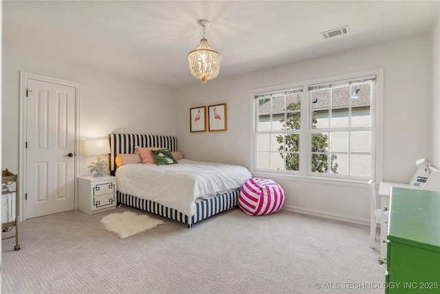 carpeted bedroom with a notable chandelier